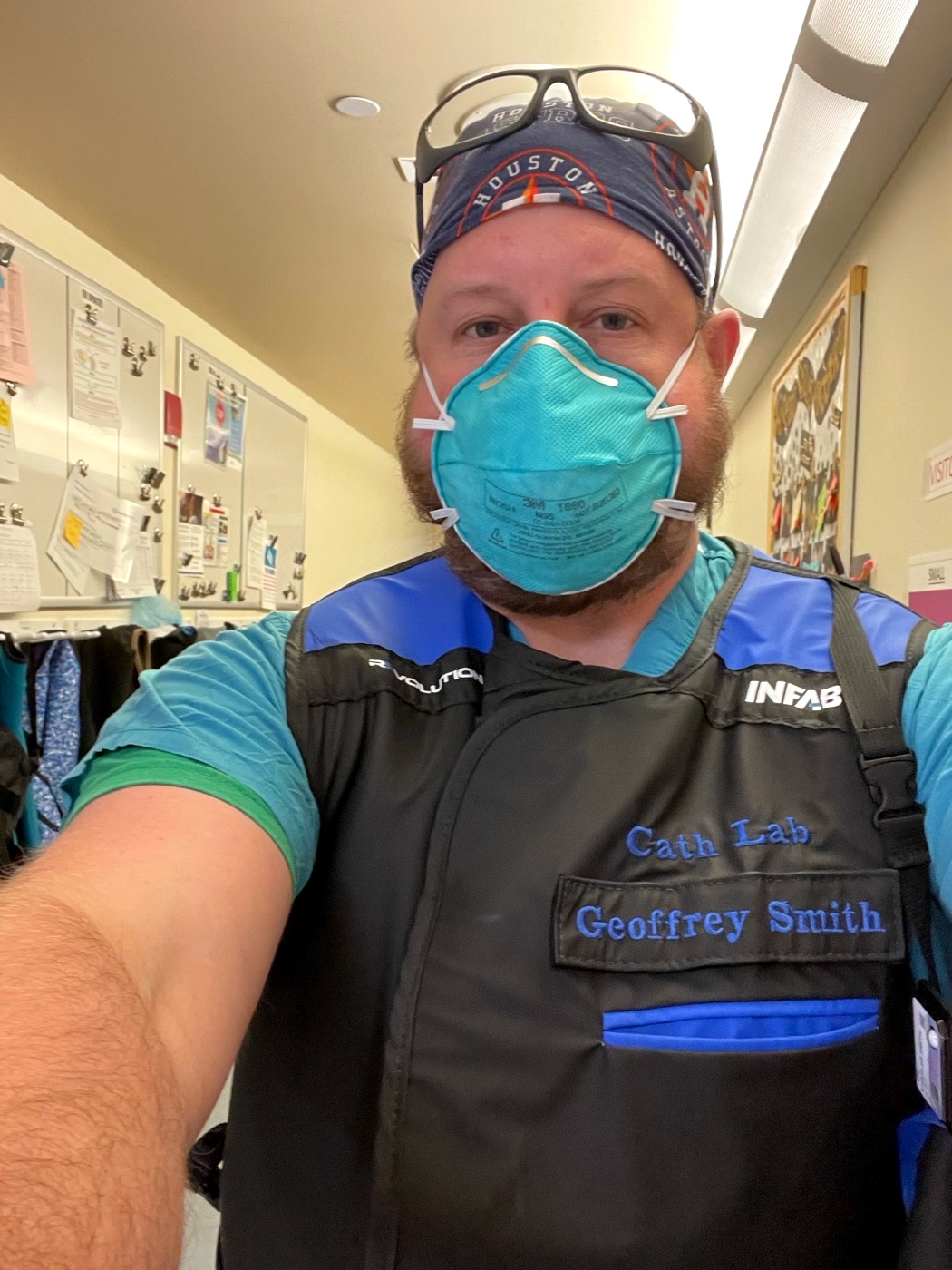 Geoffrey Smith, RN, in the cardiac cath lab — lead vest stitched “Cath Lab Geoffrey Smith”